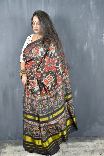 KUNJAR BHAT BLACK-FIRE BRICK RED SINGLE IKAT COTTON PATOLA SAREE WITH ZARI ANCHAL