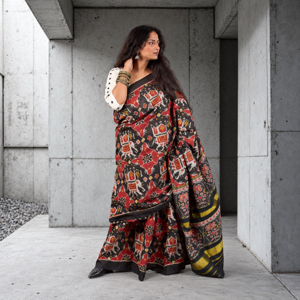 KUNJAR BHAT BLACK-FIRE BRICK RED SINGLE IKAT COTTON PATOLA SAREE WITH ZARI ANCHAL
